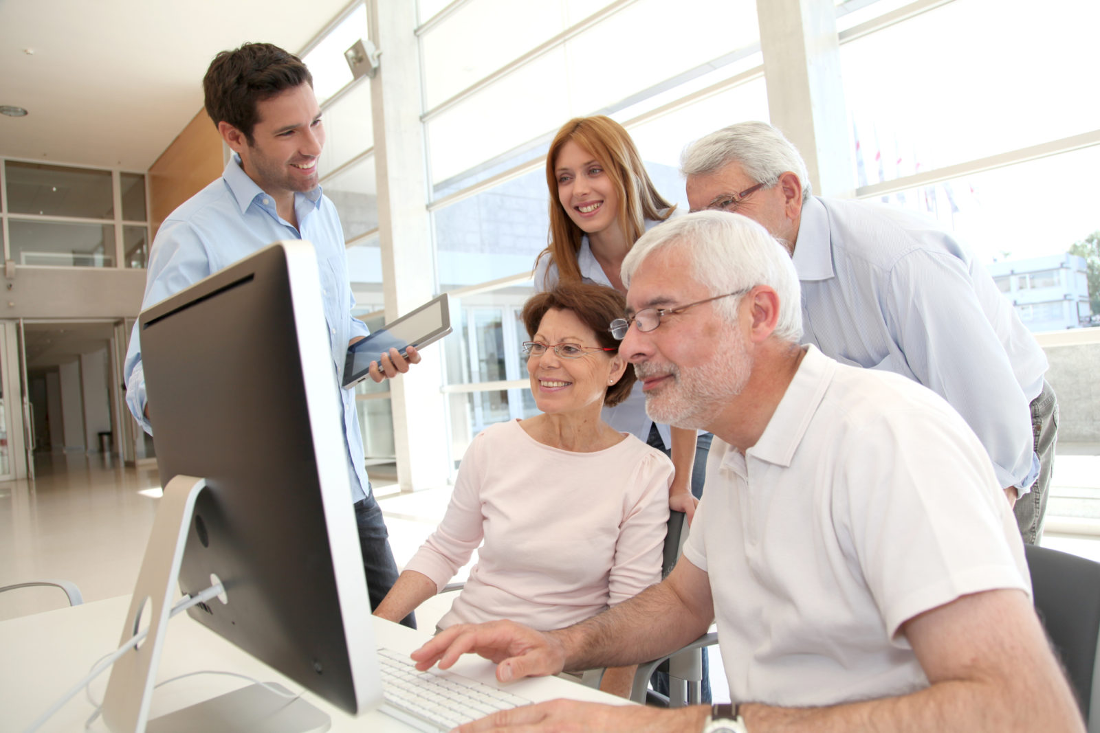Group of senior people in front of desktop computer