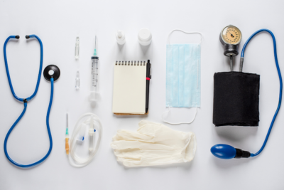 Stethascope and various other medical instruments on a clean, white background