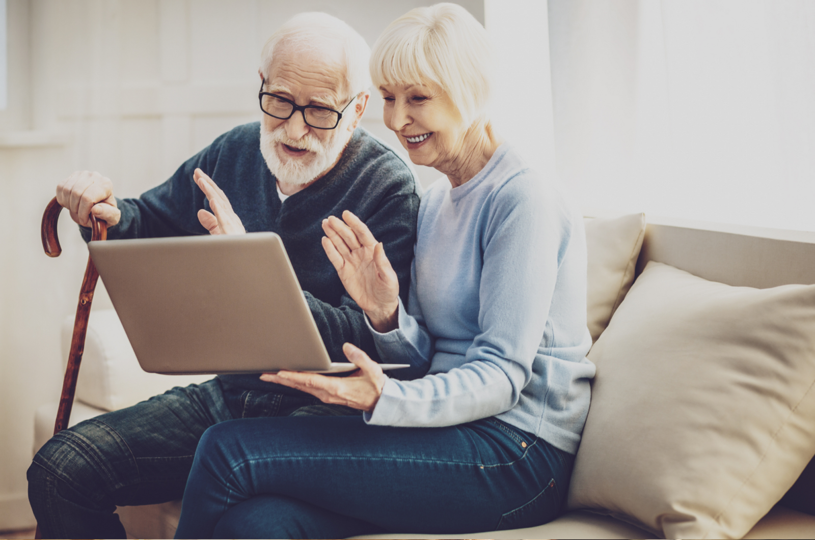 elderly couple using laptop video call