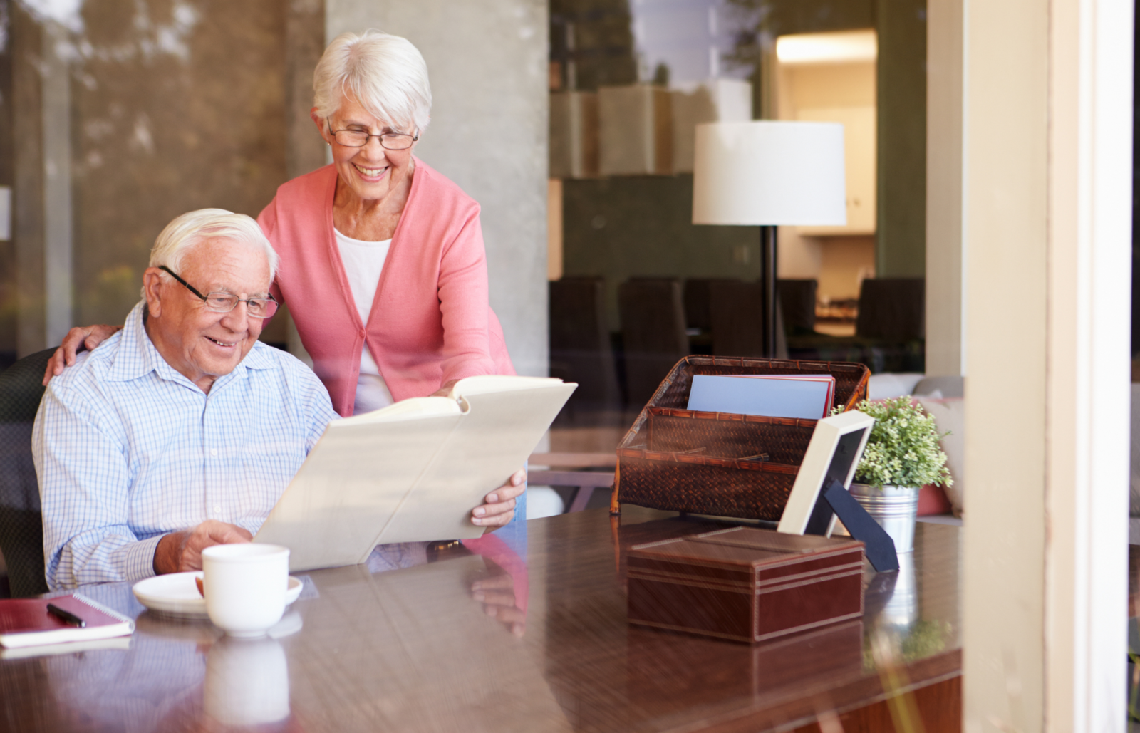 elderly couple looking at legacy book